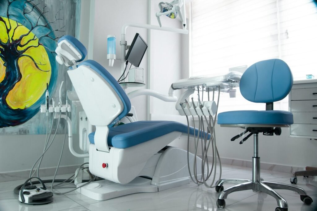 a dentist chair in a room with a painting on the wall